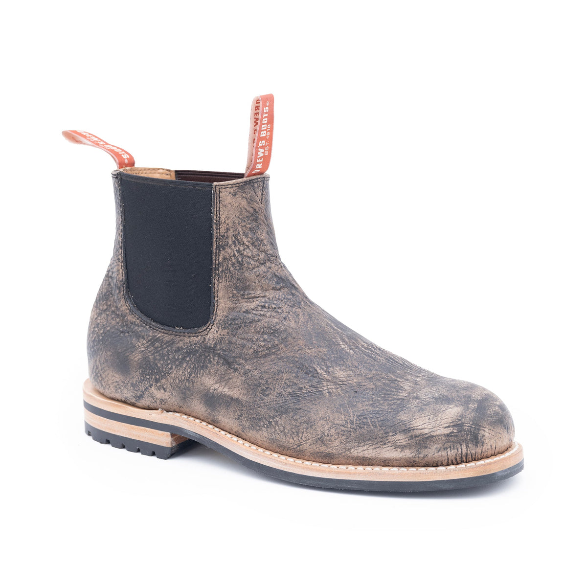 Worn leather Chelsea boot on a white background