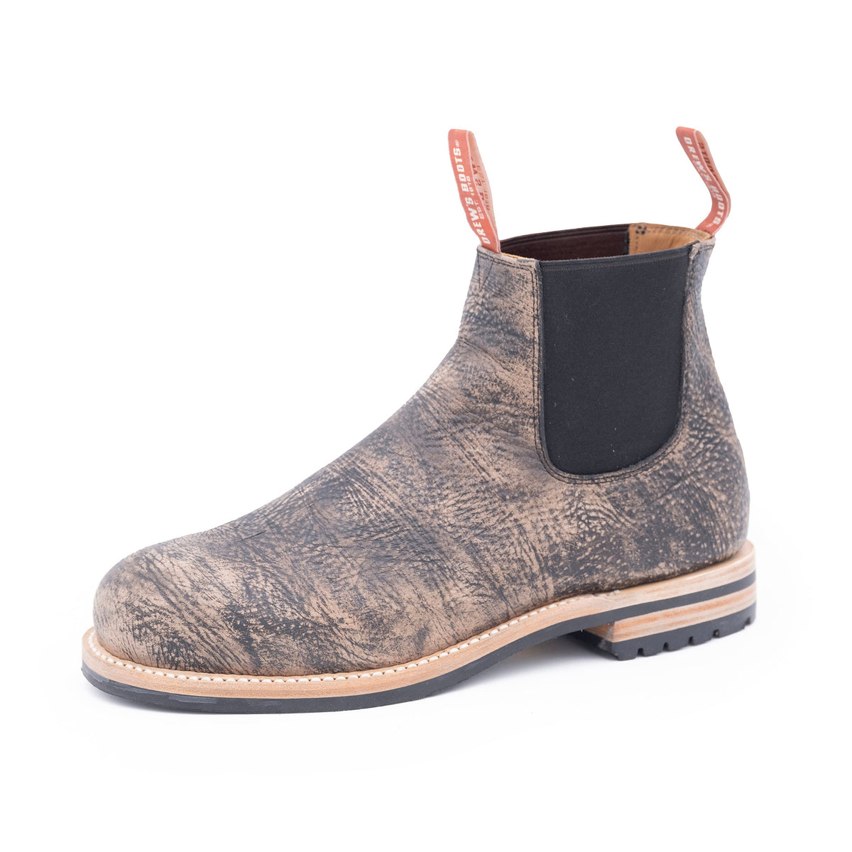 Gray chelsea boot with a black pull tab on a white background