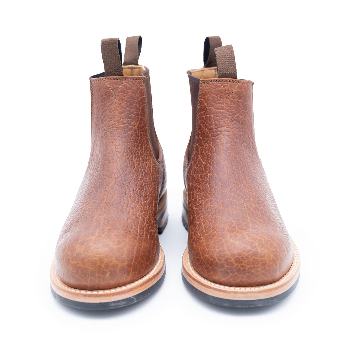 Pair of brown leather boots on a white background